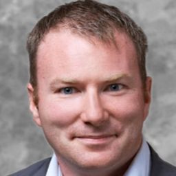 A white male with short brown hair looking at the camera with a slight smile. 